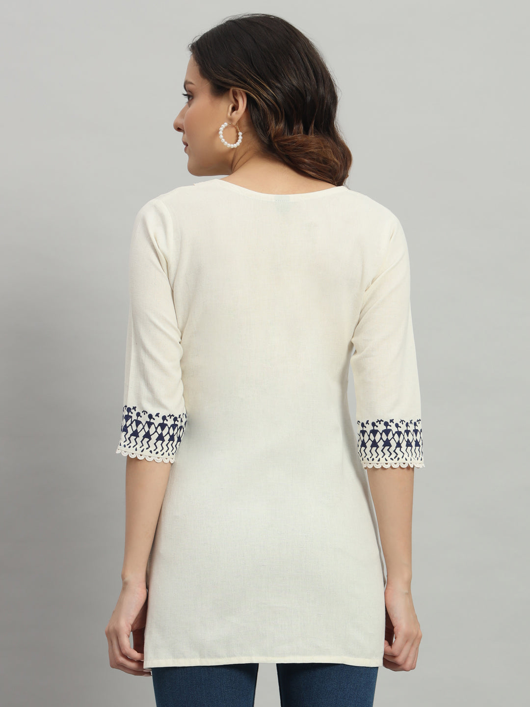 Elegant cream cotton kurti adorned with intricate blue warli print