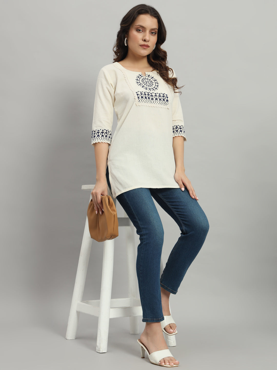 Elegant cream cotton kurti adorned with intricate blue warli print